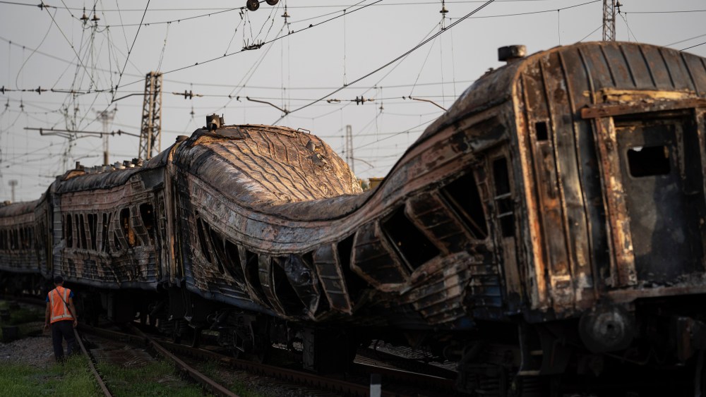 Image: A railway worker surveys a damaged train after an alleged Russian attack in the village of Chaplyne, Ukraine, on Aug. 25, 2022.
