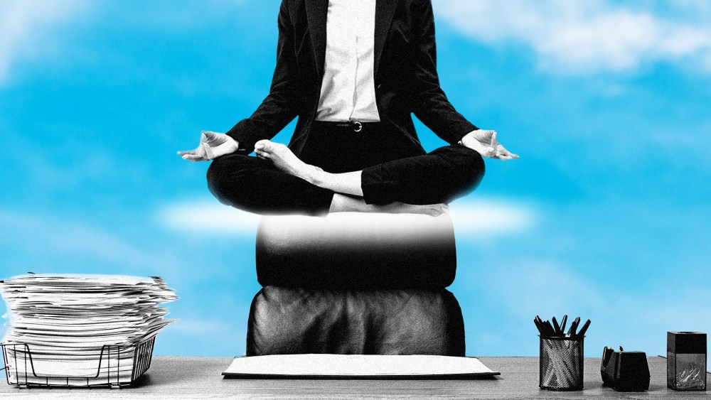 Photo illustration: Partial view of a woman in a suit levitating above a work desk against the sky in the background.