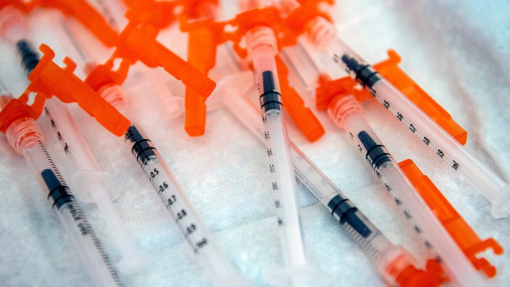 Image: Syringes on a table.