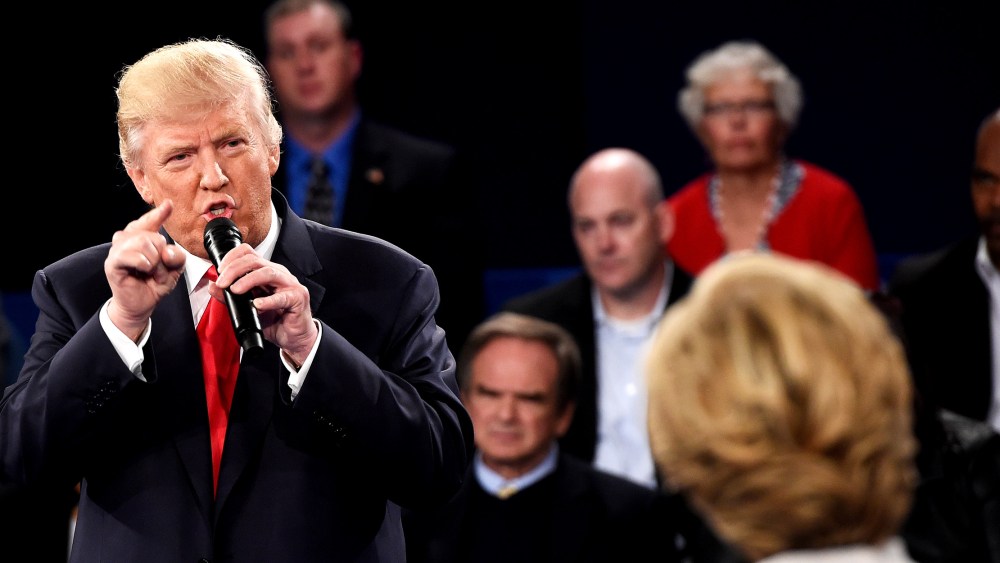 Image: Donald Trump speaks as Hillary Clinton looks on during a town hall debate.