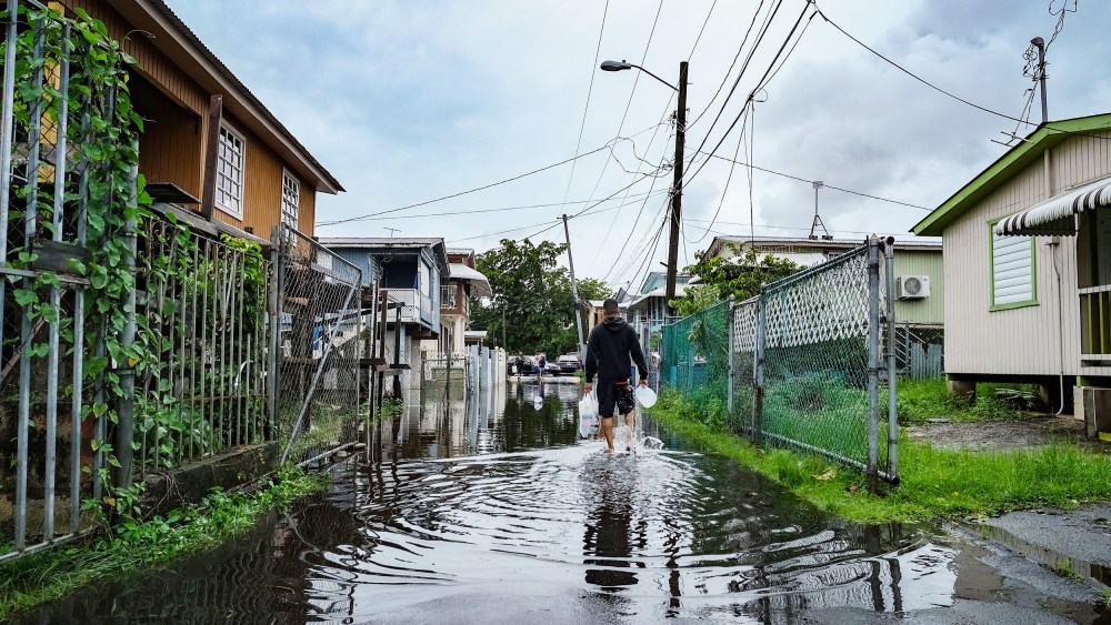 A man walks down a flooded street in the Juana Matos neighborhood of Catano, Puerto Rico on Monday after the passage of Hurricane Fiona.