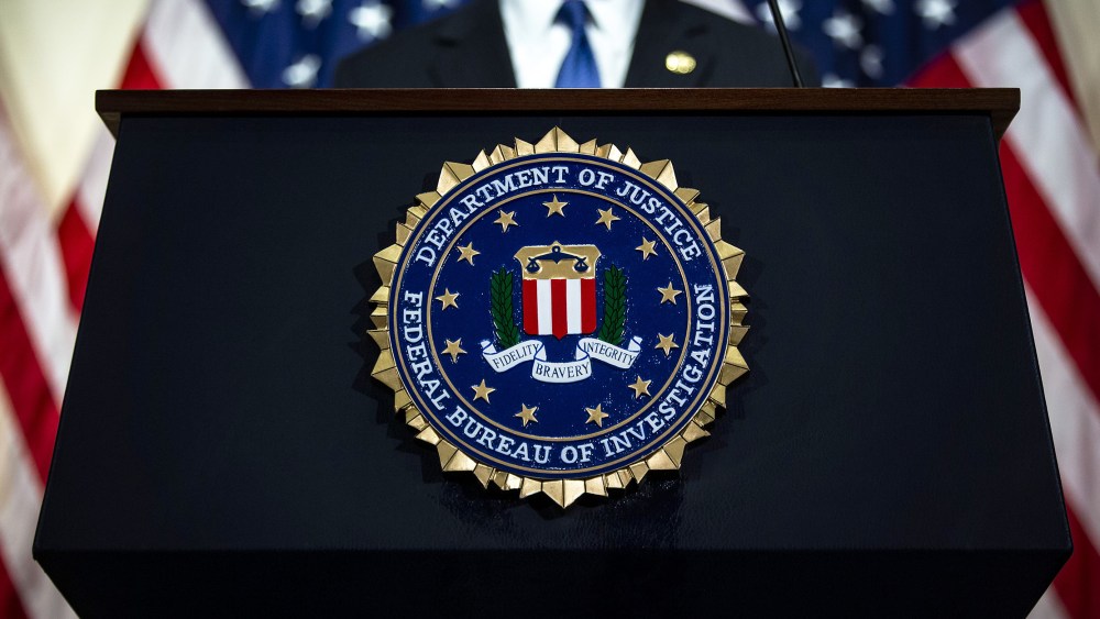 Image: The seal of the Federal Bureau of Investigation (FBI) hangs on a podium during a news conference.