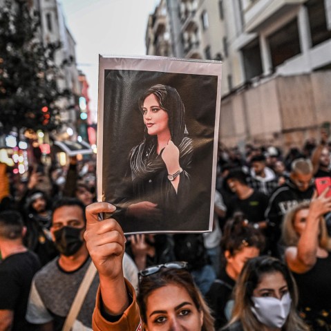 Image: A protester holds a portrait of Mahsa Amini during a demonstration in support of Amini in Istanbul