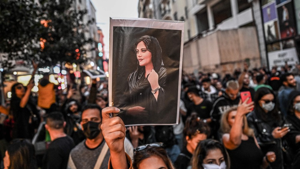 Image: A protester holds a portrait of Mahsa Amini during a demonstration in support of Amini in Istanbul