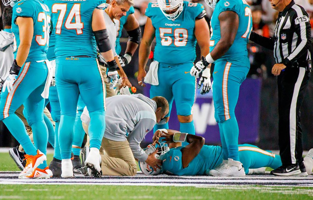 Image: Miami Dolphins quarterback Tua Tagovailoa is attended by medical staff.