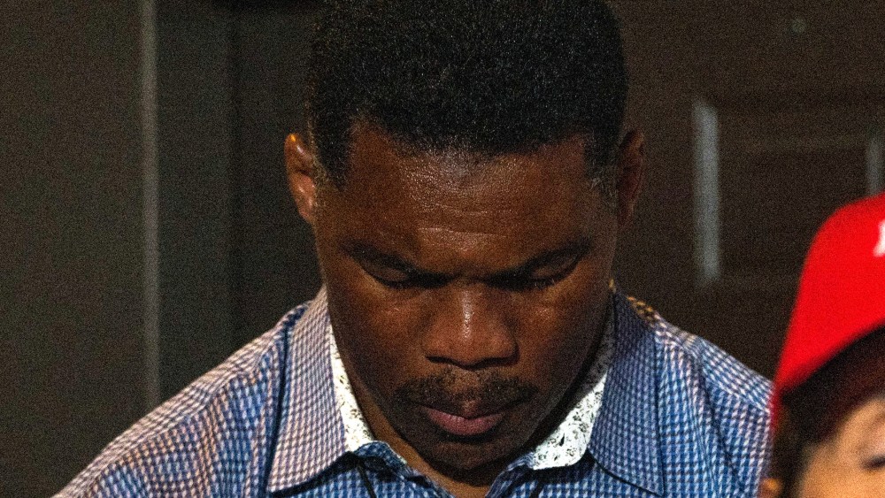 Image: Republican candidate for U.S. Senate Herschel Walker prays before speaking at a rally in Athens, Georgia