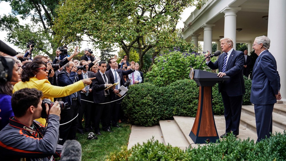 April Ryan, left, the Washington bureau chief for American Urban Radio Networks asks questions to President Donald Trump and Senate Majority Leader Mitch McConnell of Ky., in the Rose Garden of the White House on Oct. 16, 2017.