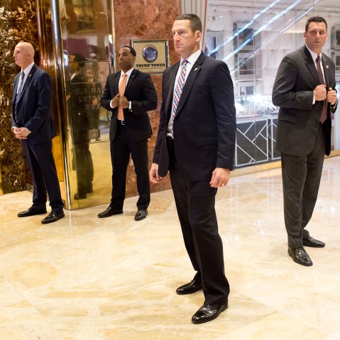 Image: A secret service detail clears out the lobby in the Trump Tower.