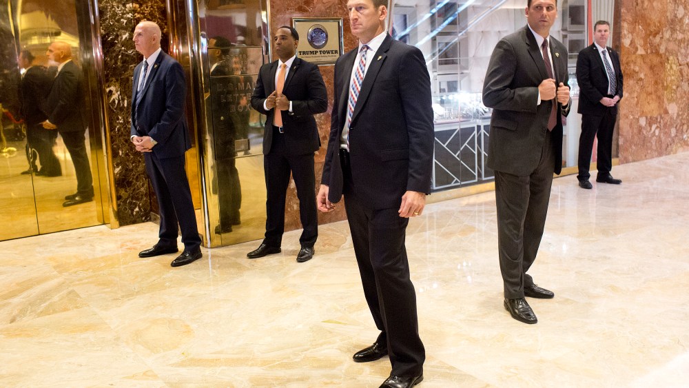 Image: A secret service detail clears out the lobby in the Trump Tower.