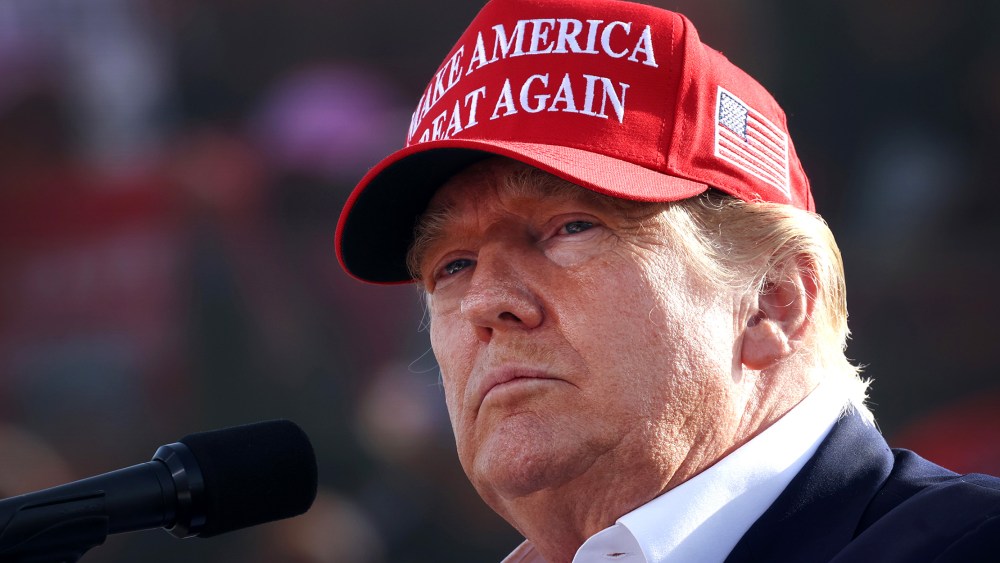 Image: Donald Trump wearing a red hat that reads,"Make America Great Again".