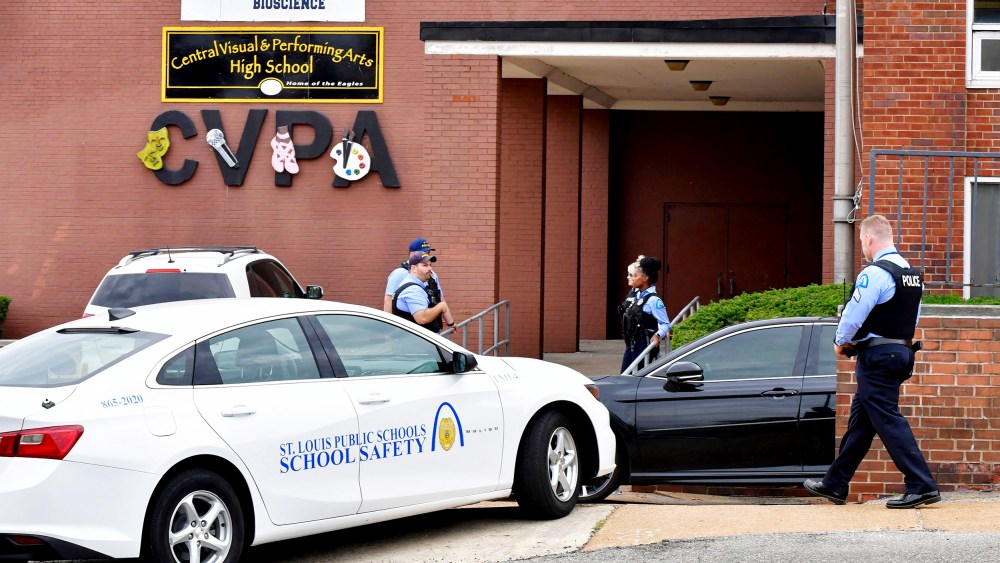St. Louis metropolitan police officers stand outside an entrance at the northeast corner of the Central Visual and Performing Arts High School after a shooting that left three people dead including the shooter today in St Louis, Miss.