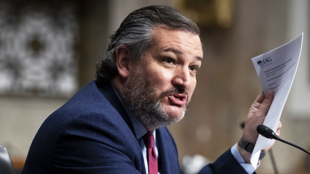 Image: Sen. Ted Cruz holds up a set of papers.