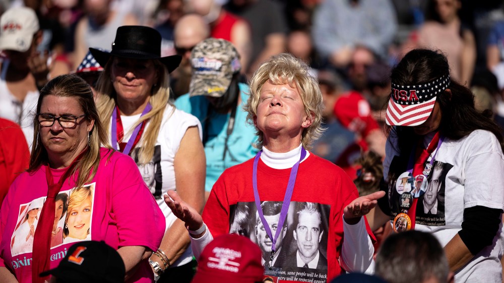 A crowd bows their heads in prayer during the invocation during a rally hosted by former President Donald Trump at the Delaware County Fairgrounds on April 23 in Delaware, Ohio.