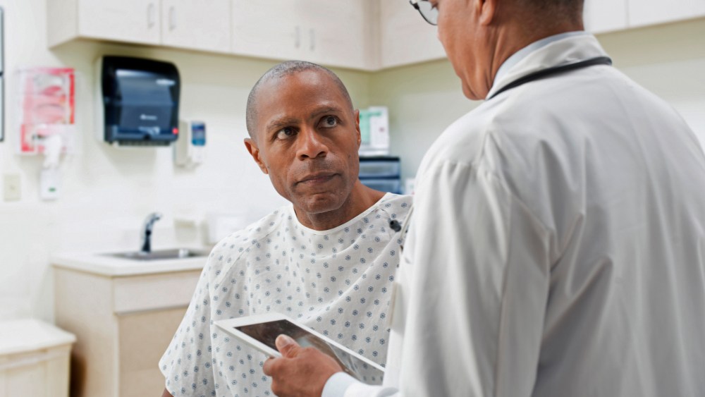 Doctor talking to patient in office.