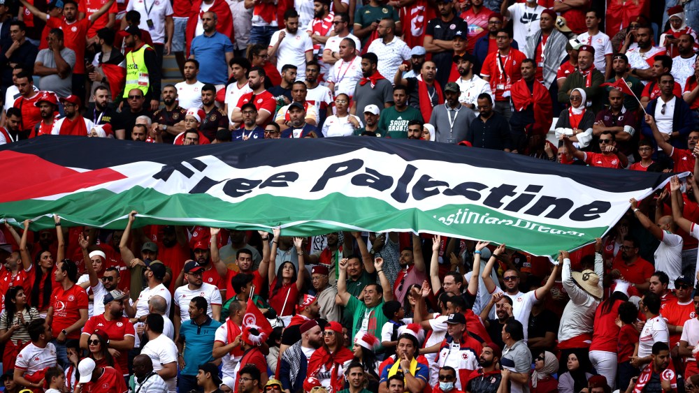 Image: Fans hold a "Free Palestine" banner at a World Cup match between Tunisia and Australia in Al Wakrah, Qatar, on Nov. 26, 2022.