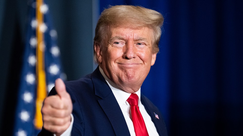Image: Former President Donald Trump give a thumbs up.