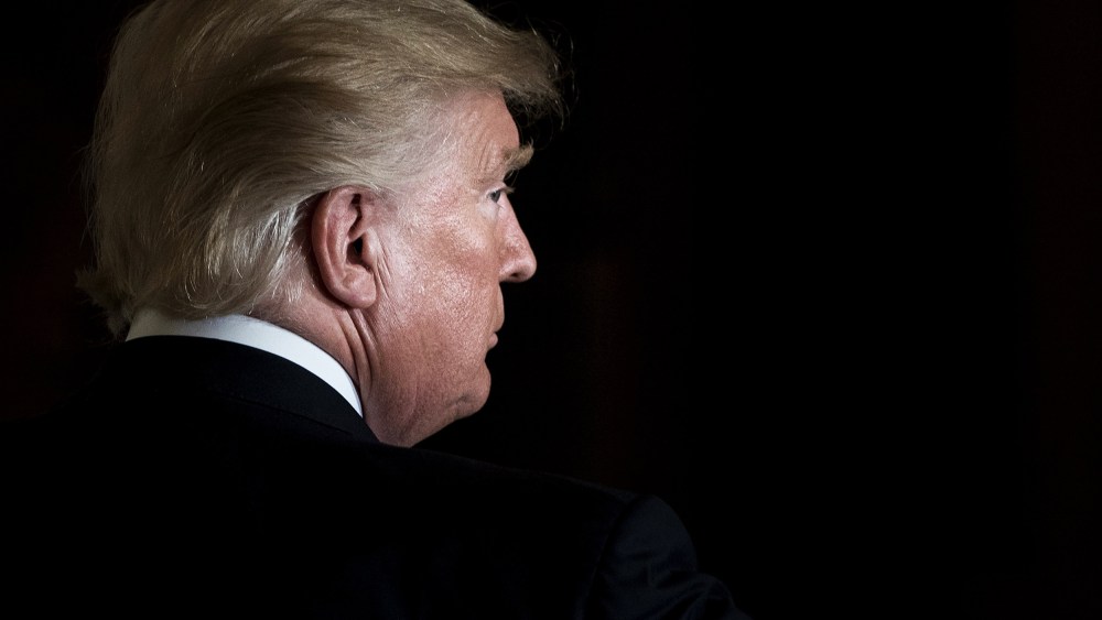 Then-President Donald Trump leaves the East Room of the White House