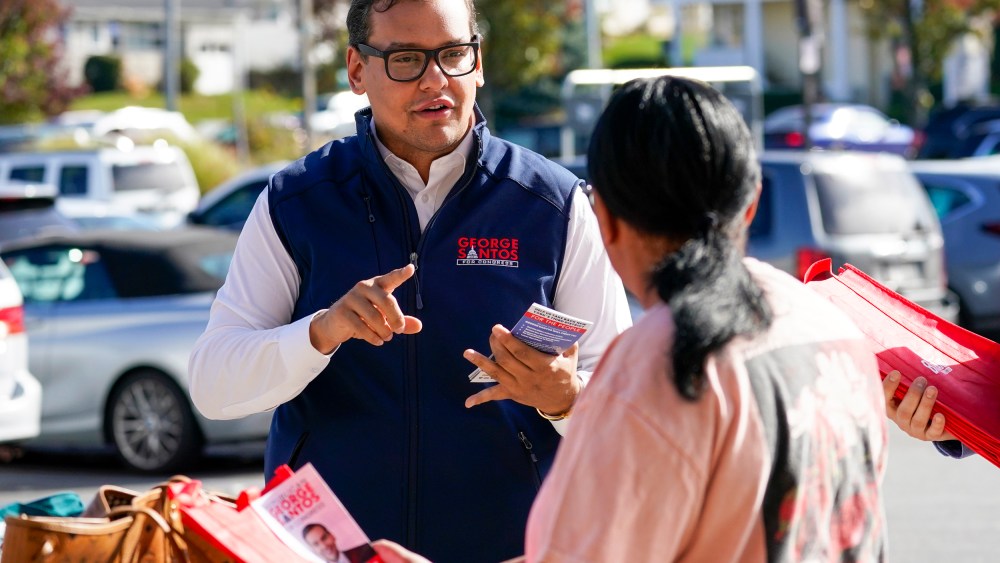 Congressman-elect George Santos talks to a voter while campaigning
