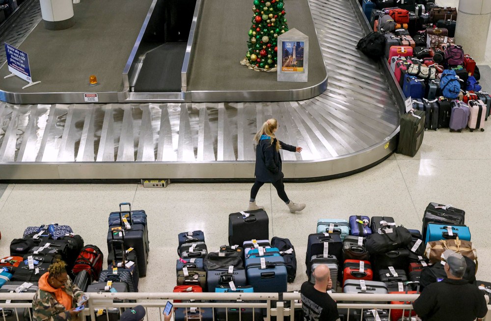 Image: Stranded Southwest Airlines passengers look for their luggage at baggage claim at Chicago Midway International Airport on Dec. 28, 2022.