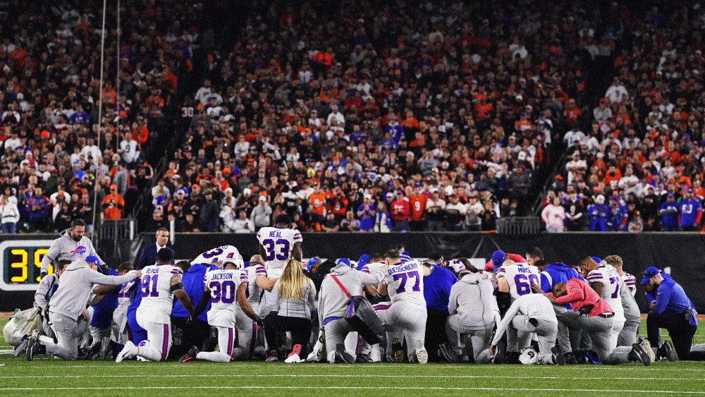 Image: Buffalo Bills players and staff take a knee after their teammate, Damar Hamlin, collapsed on the field during a game against the Cincinnati Bengals at Paycor Stadium on Jan. 2, 2023.