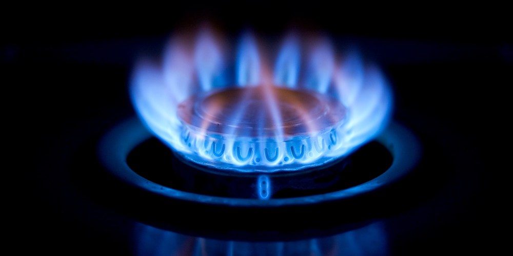 Image: Close up of a burning gas stove.