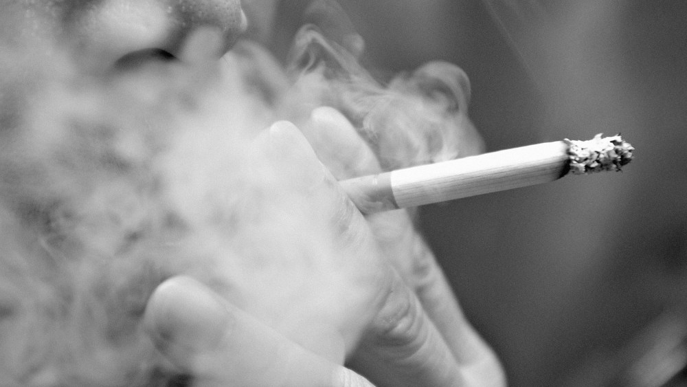Smoking a cigarette

Smoking a cigarette with smoke around and a blurred background