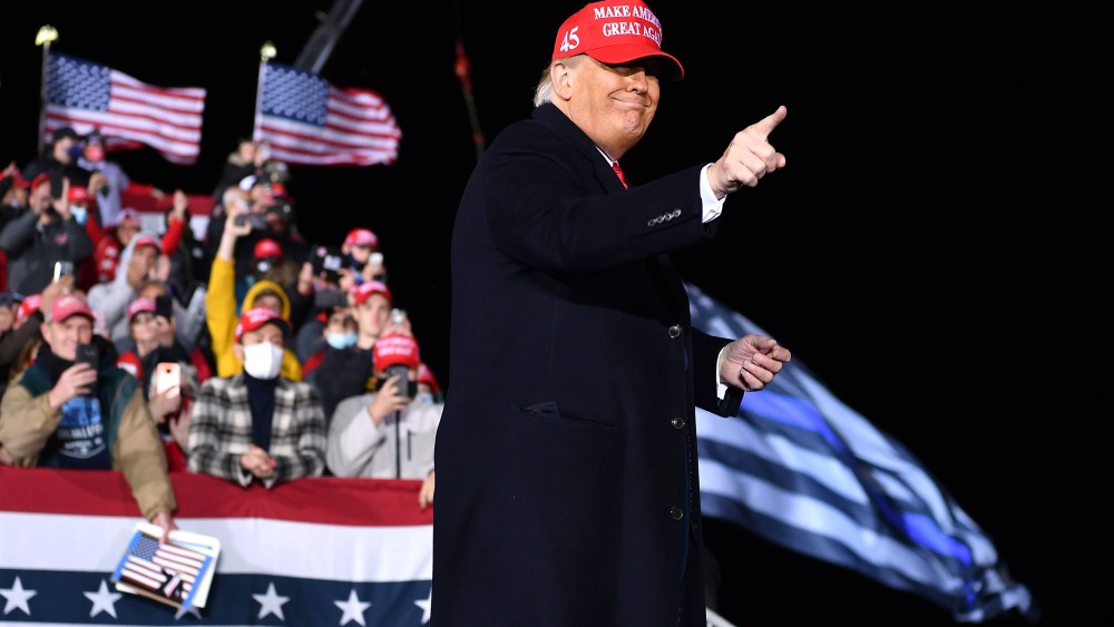 US President Donald Trump gestures during a rally at Southern Wisconsin Regional Airport in Janesville, Wisconsin on October 17, 2020.