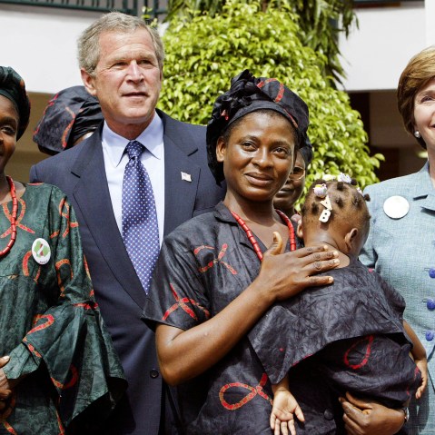 President George W. Bush and first lady Laura Bush greet local mothers affected by AIDS with their HIV-free children in the courtyard of the Abuja National Hospital and laboratory in Abuja, Nigeria, the last stop on his African tour, on July 12, 2003.