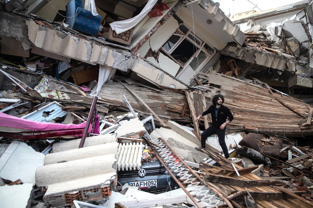 A man searches the collapsed building to hear a sound from his loved ones, on February 07, 2023 in Hatay, Turkey. A 7.8-magnitude earthquake hit near Gaziantep, Turkey, in the early hours of Monday, followed by another 7.5-magnitude tremor just after midday. The quakes caused widespread destruction in southern Turkey and northern Syria and were felt in nearby countries.