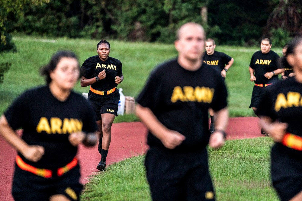 Image: Students in the new Army prep course run around a track during physical training exercises at Fort Jackson in Columbia, S.C., on Aug. 27, 2022.