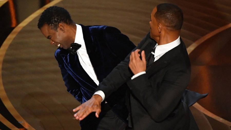 TOPSHOT - US actor Will Smith (R) slaps US actor Chris Rock onstage during the 94th Oscars at the Dolby Theatre in Hollywood, California on March 27, 2022. (Photo by Robyn Beck / AFP) (Photo by ROBYN BECK/AFP via Getty Images)