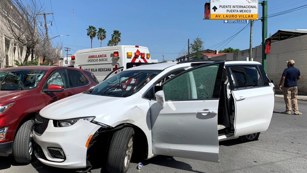 A member of the Mexican security forces stands near a white minivan with North Carolina plates and several bullet holes, at the crime scene where gunmen kidnapped four U.S. citizens who crossed into Mexico from Texas, on March 3, 2023.
