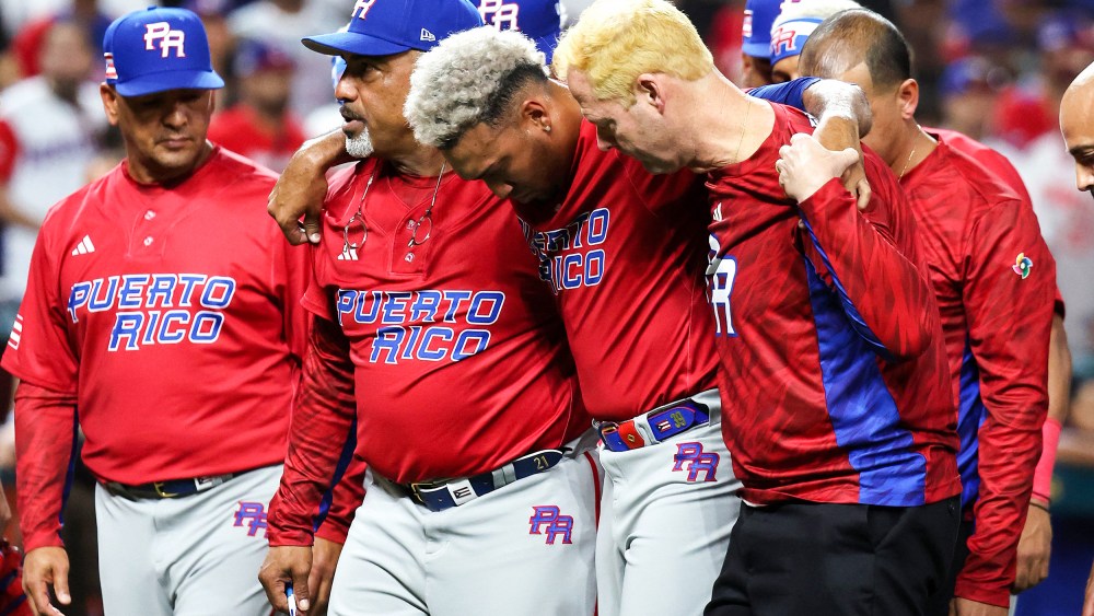 Edwin Diaz of Puerto Rico is helped off the field after being injured during the on-field celebration after defeating the Dominican Republic during the World Baseball Classic Pool D on March 15, 2023, in Miami.