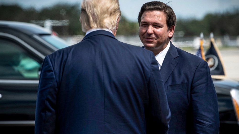 President Donald Trump is greeted by Florida Governor Ron DeSantis at Southwest Florida International Airport Oct. 16, 2020, in Fort Myers, Fla.