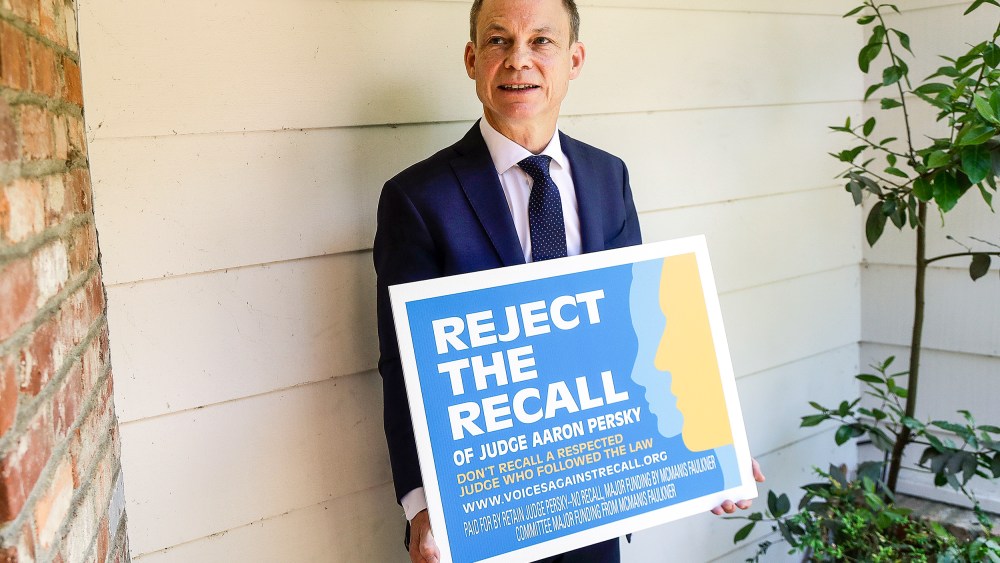 Judge Aaron Persky holds a sign opposing his recall in Los Altos Hills, Calif., on May 15, 2018.