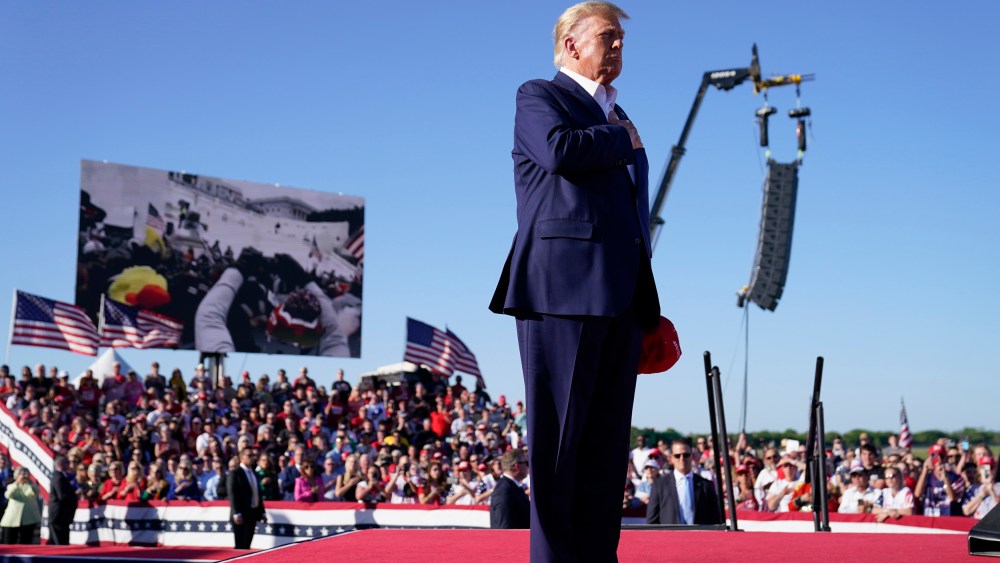 Donald Trump stands while  "Justice for All," is played during a campaign rally, in Waco, Texas