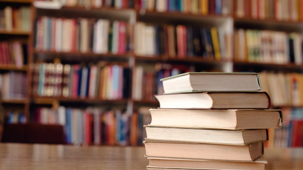 Close up of books on desk in library.

Books