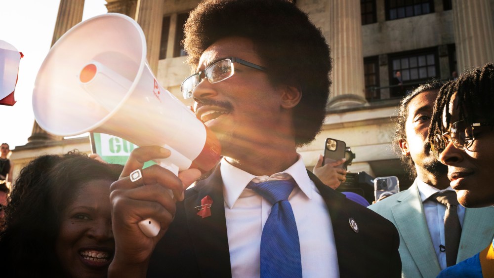 Expelled State Rep. Justin Pearson delivers remarks through a megaphone outside the Tennessee Capitol in Nashville