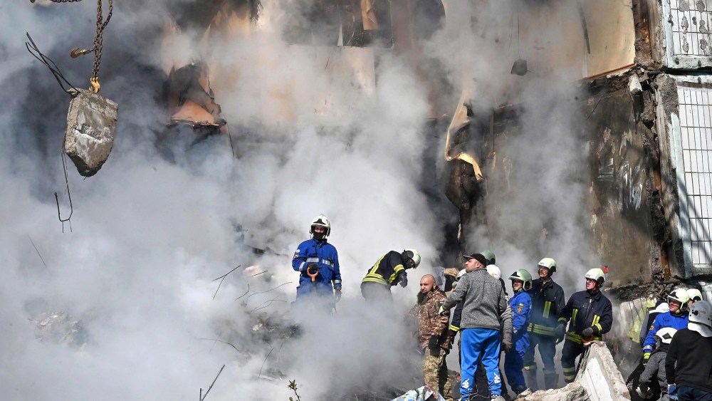 Rescuers search for survivors in the rubble of a damaged residential building in Uman, around 215km south of Kyiv, on April 28, 2023, after Russian missile strikes targeted several Ukrainian cities overnight. - Ukraine and Russia have been fighting since Moscow's February 2022 invasion and Ukraine says it has been preparing for months a counter-offensive aimed at repelling Russian forces from the territory they currently hold in the east and south.