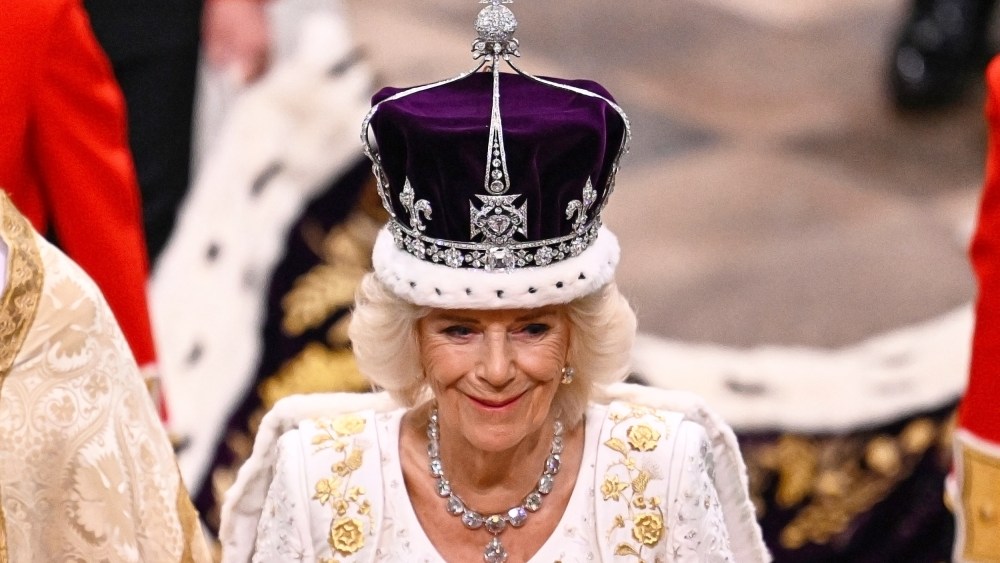 Queen Camilla smiles as she wears a modified version of Queen Mary's Crown during the Coronation Ceremony