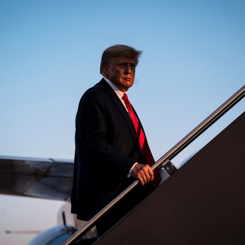 Former President Donald Trump boards his airplane after speaking at a campaign event in Manchester, N.H.