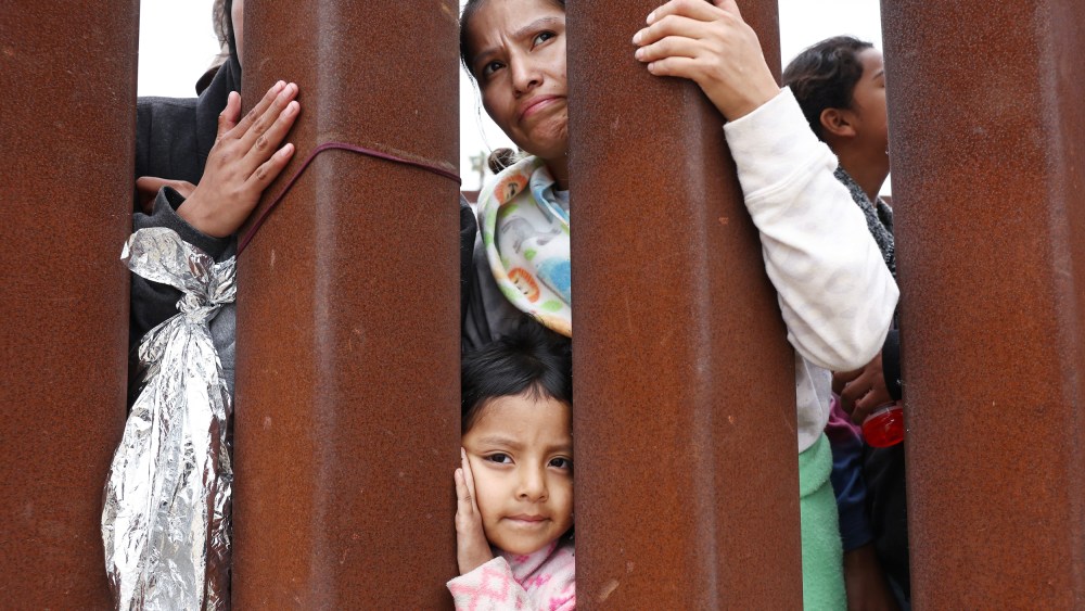 Ecuadorian mother Miriam stands with her daughter Aylin, 4, as they await volunteer assistance while stuck in a makeshift camp between border walls on May 13, 2023 in San Diego.