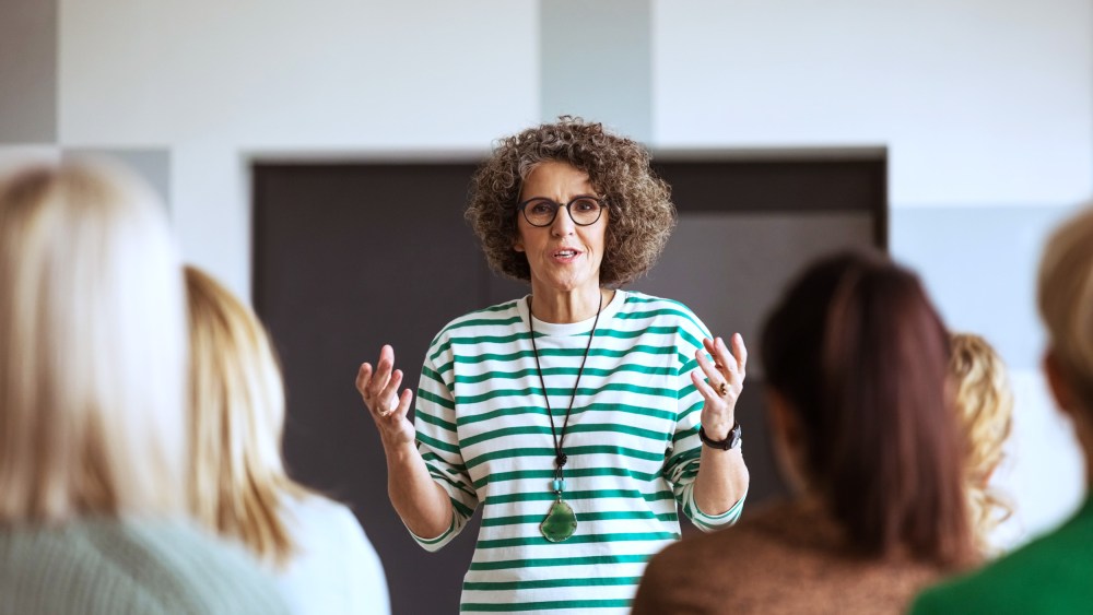 A woman speaks during a seminar.