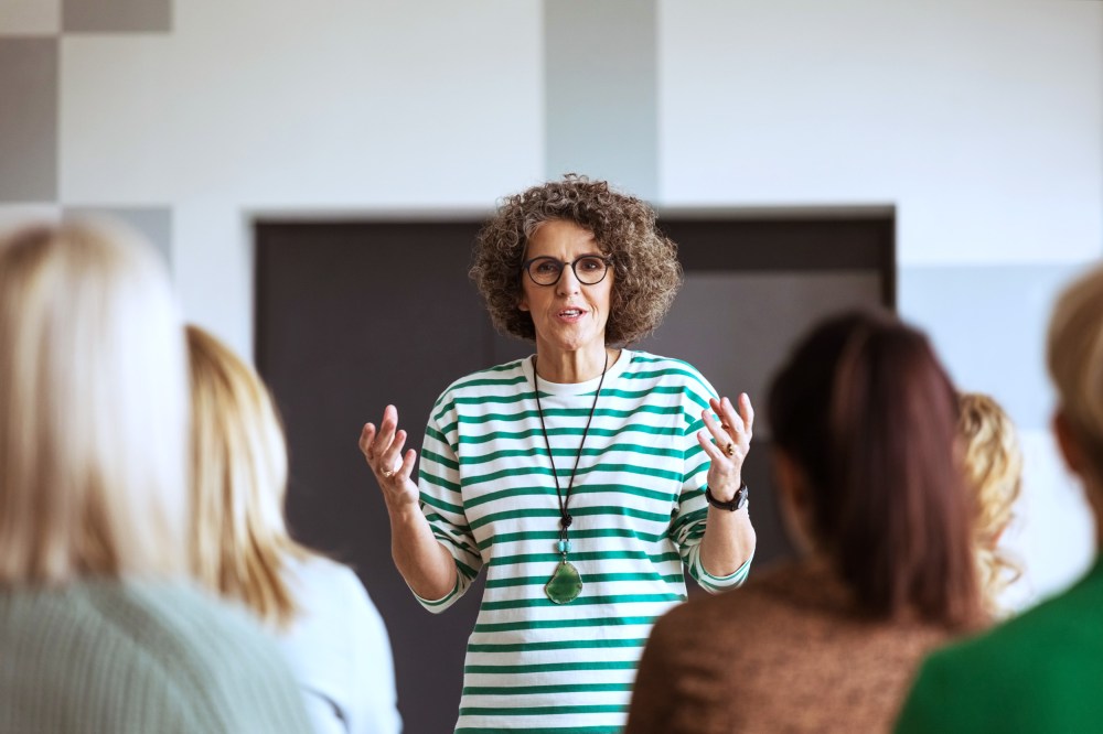 A woman speaks during a seminar.