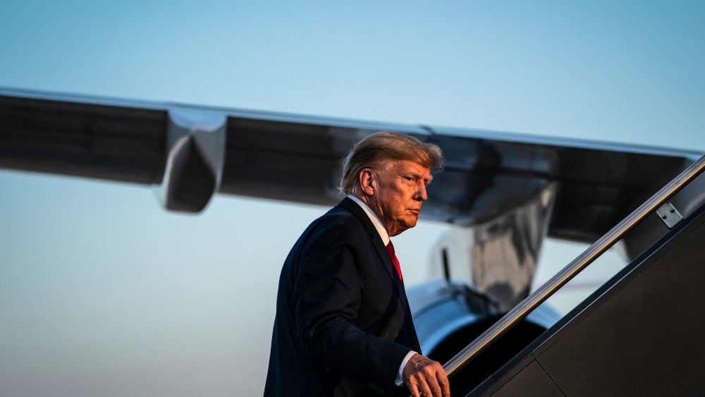 Former President Donald Trump boards his airplane after speaking at a campaign event on April 27, 2023, in Manchester, NH.