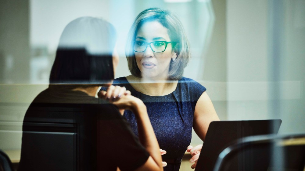Businesswoman in discussion with client in office conference room