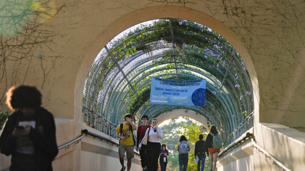 Students cross a bridge linking different sections of the campus, at New College of Florida on Feb. 28, 2023, in Sarasota.