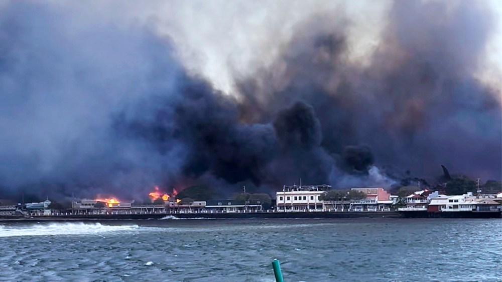 In this photo provided by Brantin Stevens smoke fill the air from wild fires at Lahaina harbor on Tuesday, Aug. 8, 2023 in Hawaii. Fire was widespread in Lahaina Town, including on Front Street, a popular shopping and dining area, County of Maui spokesperson Mahina Martin said by phone early Wednesday. Traffic has been very heavy as people try to evacuate the area, and officials asked people who weren’t in an evacuation area to shelter in place to avoid adding to the traffic, she said.