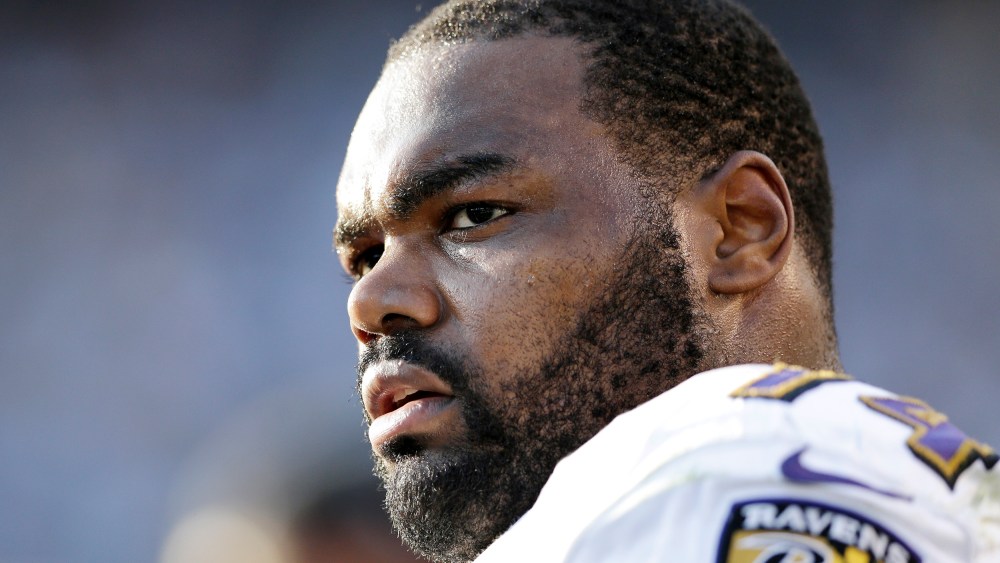 In this Nov. 25, 2012 photo, Baltimore Ravens tackle Michael Oher sits on the sidelines during the second half of an NFL football game against the San Diego Chargers, in San Diego. Oher and his adoptive family were depicted in the book and movie, "The Blind Side." Oher will play in his first Super Bowl on Sunday, Feb. 3, 2013, in New Orleans, which is where his adoptive father grew up and went to high school with author Michael Lewis, who wrote "The Blind Side." (AP Photo/Gregory Bull)