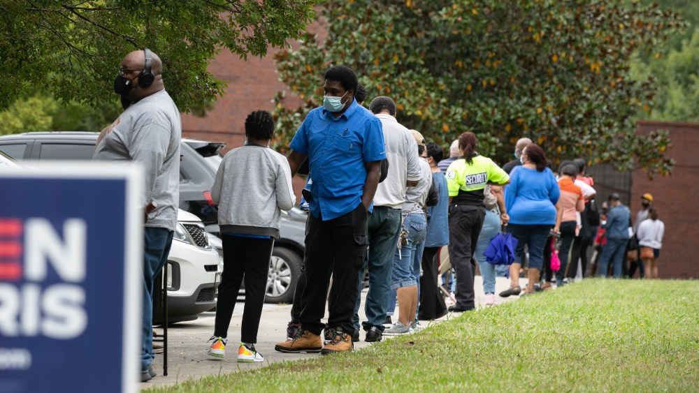 People stand in line to early voting in the general election in Atlanta